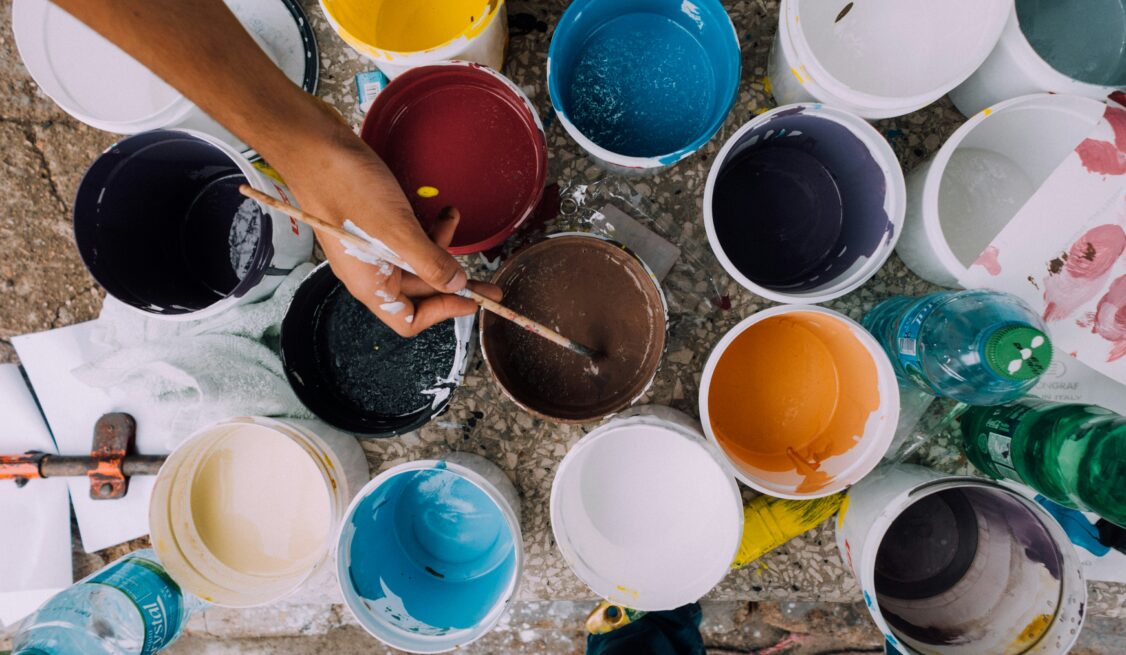 Several individual buckets of paint