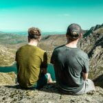 Two men looking over a cliff