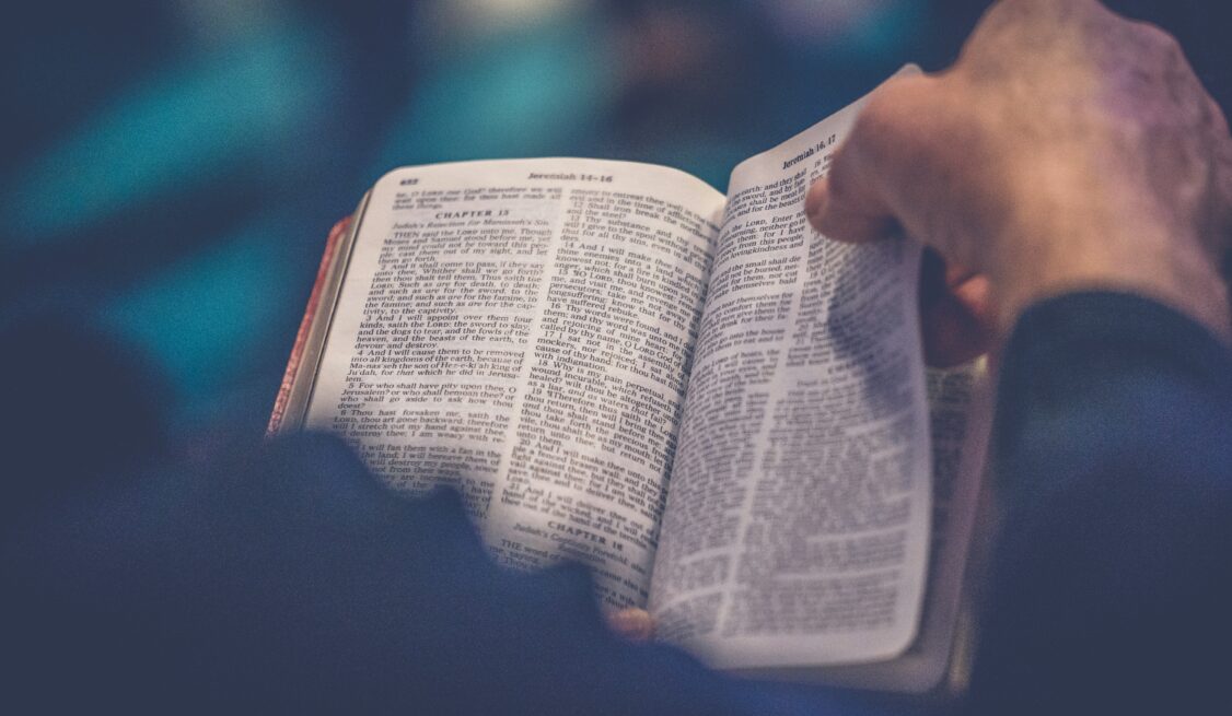 A follower flipping through the pages of the Bible