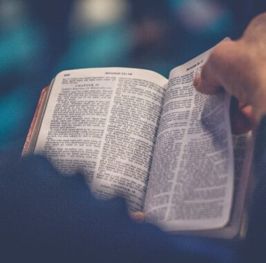 A follower flipping through the pages of the Bible