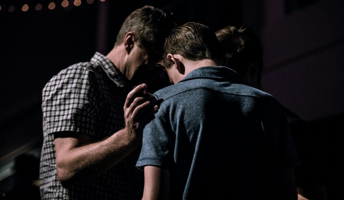 A father and son praying together