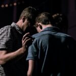 A father and son praying together