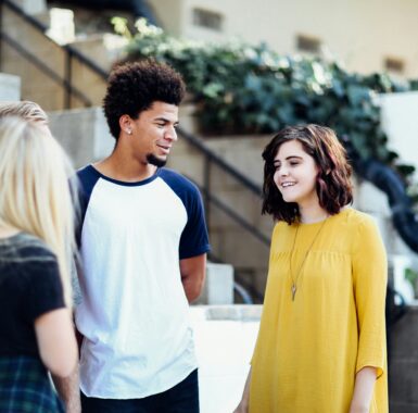 A diverse group of young people talking together