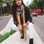Gay black woman wearing a rainbow scar on the sidewalk