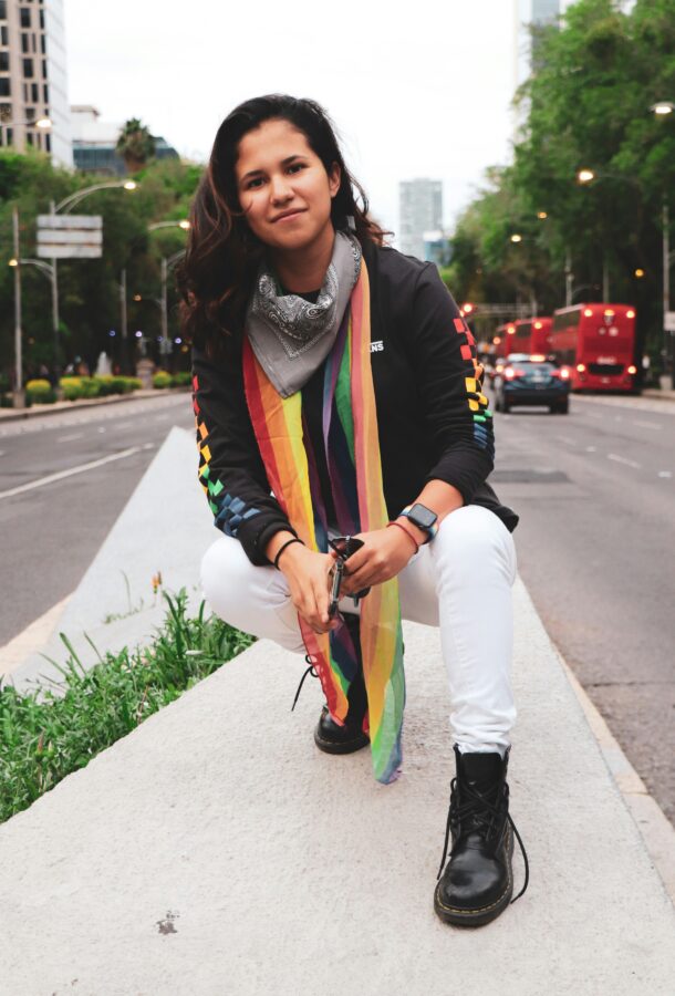 Gay black woman wearing a rainbow scar on the sidewalk
