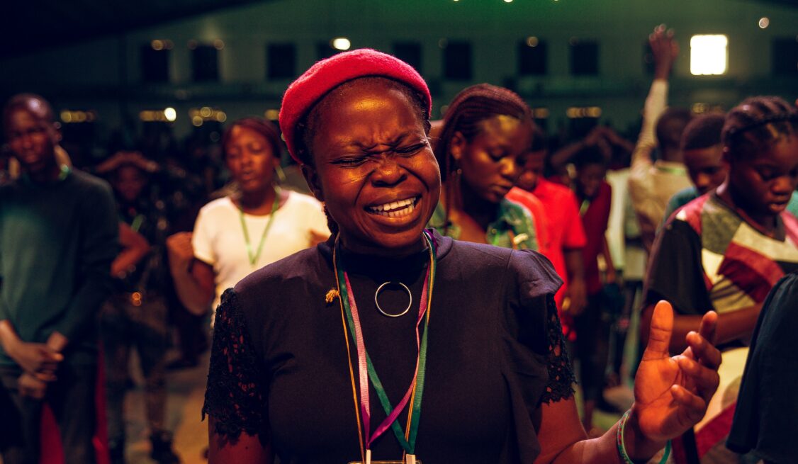 Young black woman praying sincerely